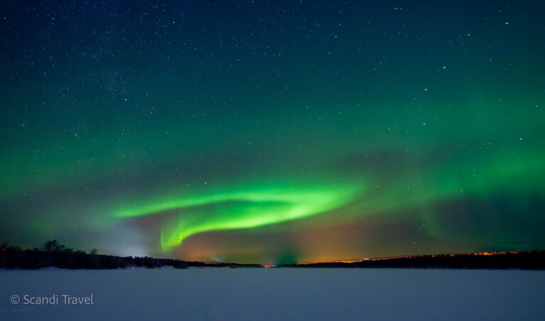 Stunning Aurora Borealis illuminating the sky above Rovaniemi, captured during a guided Northern Lights safari