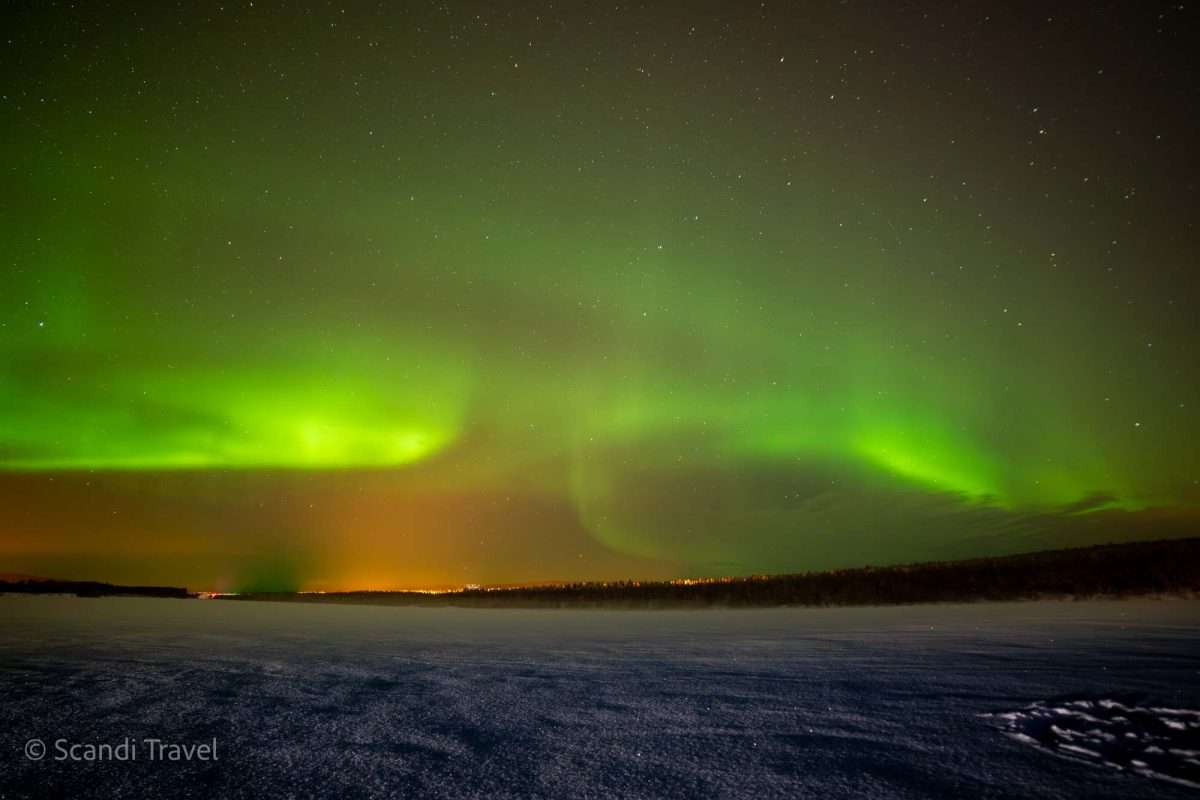 Aurora Borealis illuminating the night sky over snowy Lapland in Finland during 2024's heightened solar activity.