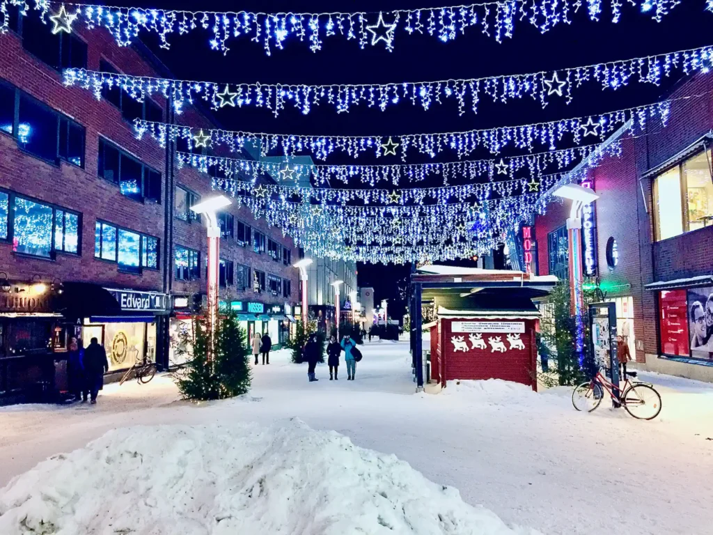 Christmas lights over a snowy pedestrian street in Rovaniemi city centre, the base of the 7-day Lapland Northern Lights tour
