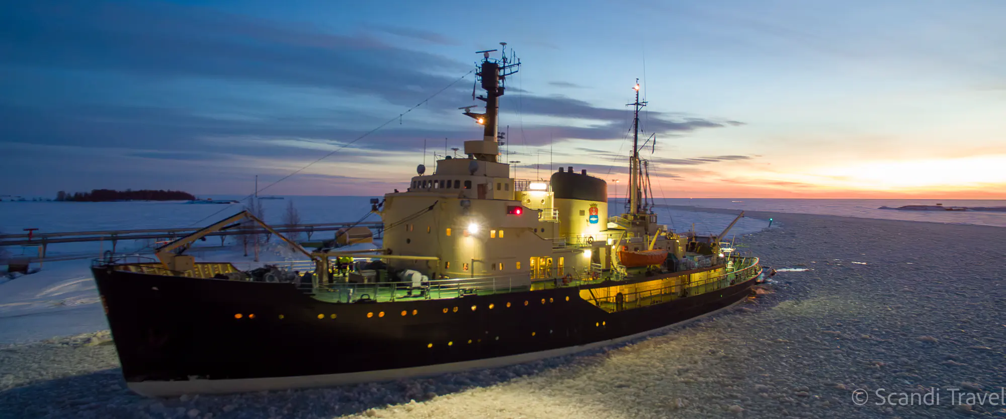 Sampo icebreaker in the frozen Gulf of Bothnia at sunset in Kemi, the icebreaker cruise of the 7-day Lapland Northern Lights tour