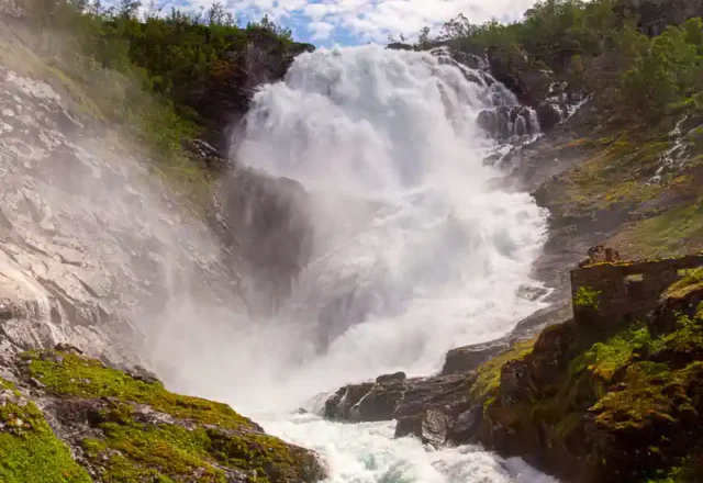 Kjosfossen waterfall along the Flåm Railway route in Norway, captured in full flow