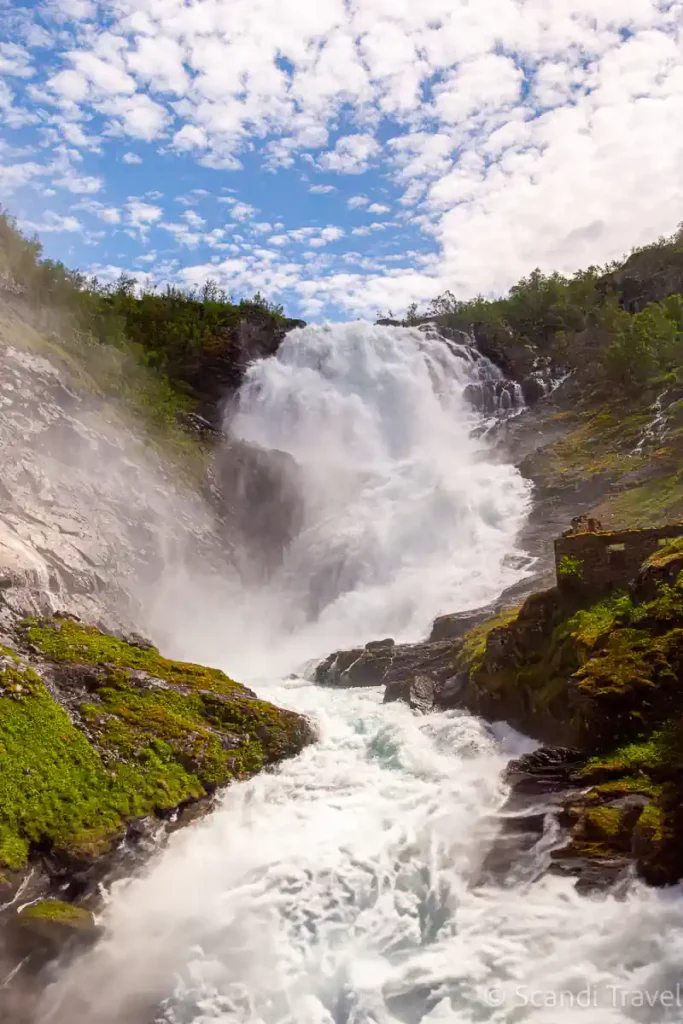 Kjosfossen waterfall along the Flåm Railway route in Norway, captured in full flow