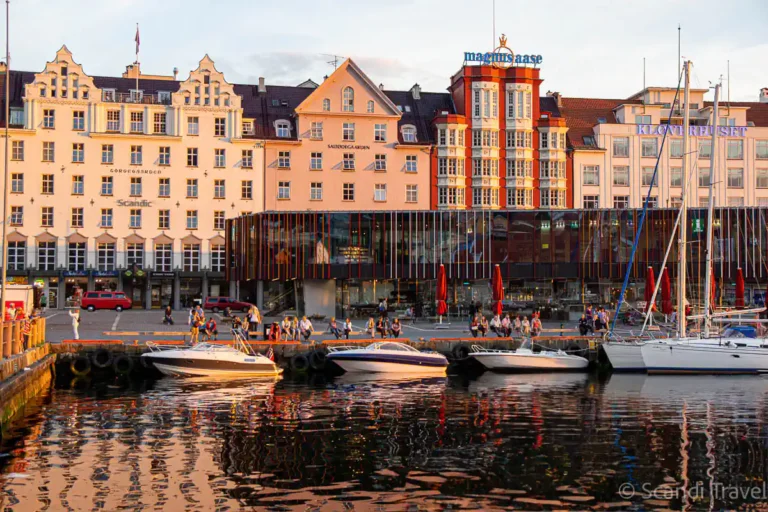 Colorful buildings and boats at the Bergen waterfront during sunset on a Scandinavian tour