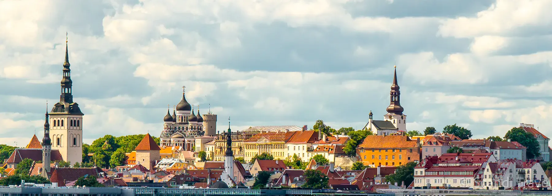 Skyline of Tallinn Old Town with the spires of St Nicholas' Church, Alexander Nevsky Cathedral and Toompea Hill under summer clouds