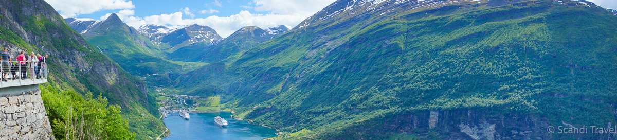 Tourists at Eagle’s Bend viewpoint overlooking Geirangerfjord with cruise ships below on Day 6 of Scandi Travel’s 10-day Scandinavia & Iceland tour