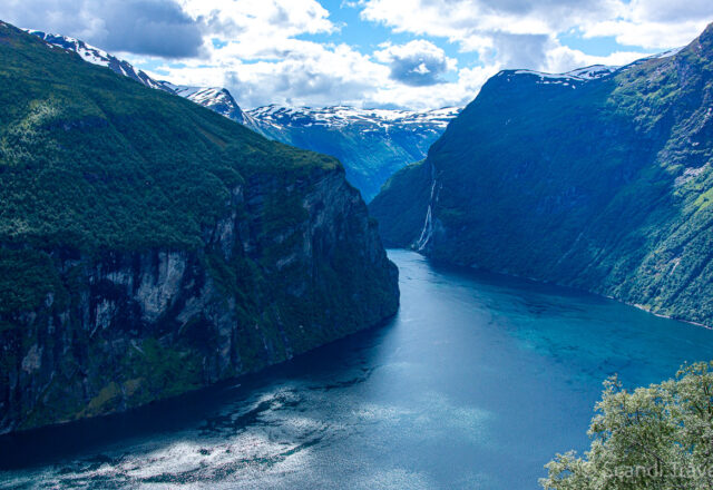 Panoramic view down the Geirangerfjord valley with towering cliffs and waterfalls on Day 6 of Scandi Travel’s tour