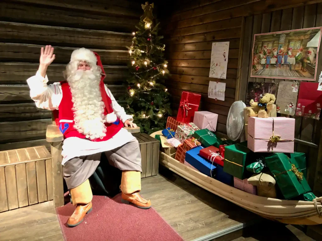 Santa Claus waving in his official office at Santa Claus Village in Rovaniemi during an 8-day Finland tour in summer and autumn.