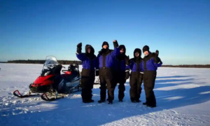Traveller dressed in full winter layering system for a Lapland winter tour in sub-zero temperatures